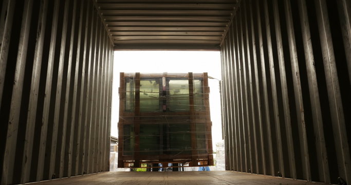 Forklift lifting loading cargo inside container view closing up