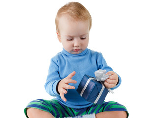 Cute little boy opens a blue gift box and rejoices, isolated on white