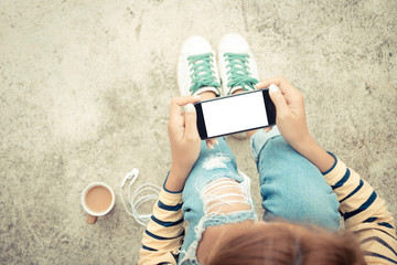 woman holding phone white screen on top view vintage style