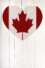 Canadian flag in heart shape on a white wooden board