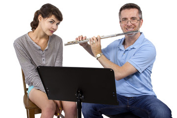 Music instructor teaching female student how to play the flute © Innovated Captures