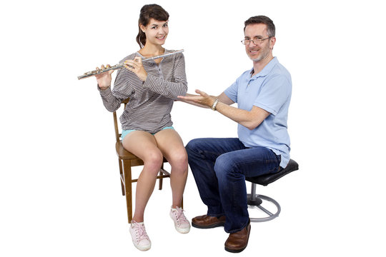 Music instructor teaching female student how to play the flute