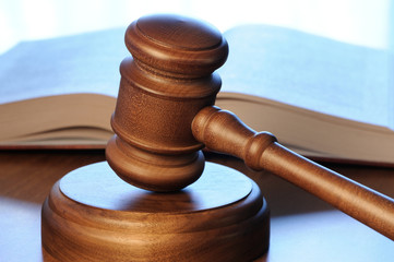 Gavel and opened book on wood table