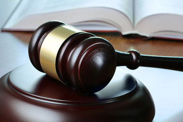 Gavel and opened book on wood table