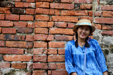 Thai woman portrait at Brick wall Background of Wat Yai chaimong