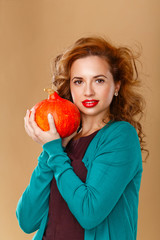 Girl with a clean skin holding a pumpkin.