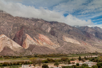 Village Maimara under colorful rock called Paleta del Pintor (Painter's Palette) in Quebrada de Humahuaca valley, Argentina