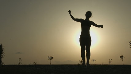 Female silhouette doing yoga exercises for harmony of healthy body and mind