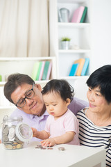 Asian family saving money indoor, financial concept, grandparent