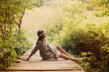 beautiful girl on old wooden brdge in forest