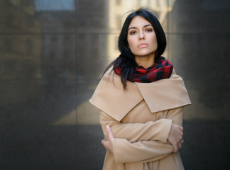 Young woman in a coat on the street.