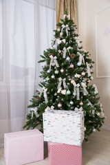 Shiny Christmas balls hanging on pine branches