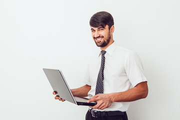 Portrait of an handsome businessman with a laptop