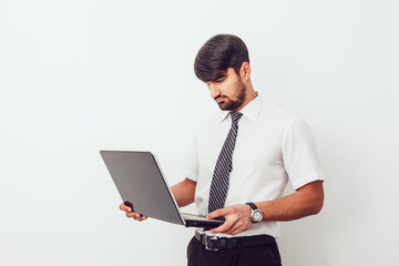 Portrait of an handsome businessman with a laptop