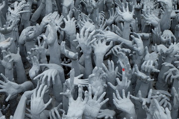 Fototapeta premium Pleading Hands Rise Up from Hell a park of Wat Rong Khun in the northern part of Thailand