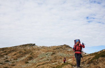 The girls go on a Hiking trail with backpacks.