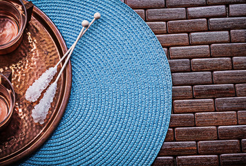 Composition of tray tea cups sugar sticks wicker table cloth