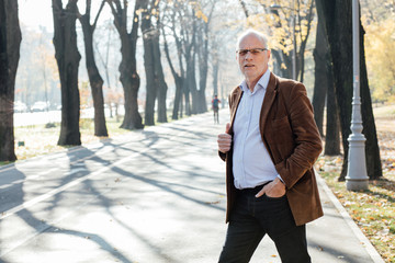 old man elegant dressed  standing outside