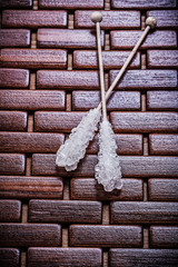Tasty sugar sticks on wooden matting food and drink concept