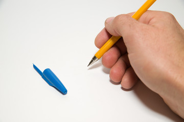 Men's right hand holding a pen on over white