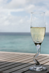 A champagne glass by the ocean