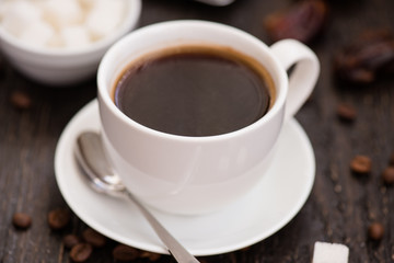 Braekfast in the morning, cup of black coffee, on the wooden tab