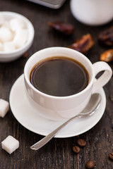 Braekfast in the morning, cup of black coffee, on the wooden tab
