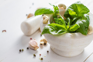 Pesto sause and ingredients on white background