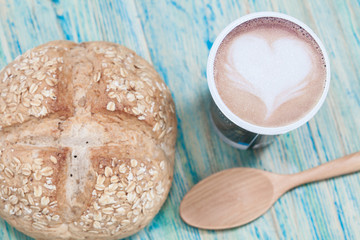 Bread with coffee cup on wood