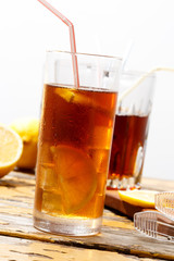 Glass of cold ice tea with lemon, condensate on glass