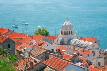 Cathedral in Šibenik, Croatia  boats in sea in background © Simun Ascic
