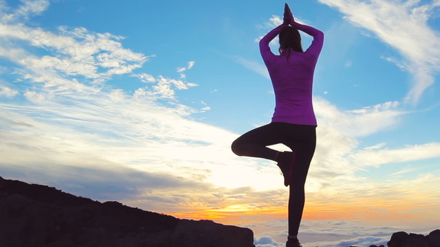 Young Woman Standing Yoga Pose on top of Mountain. Reaching the Top. Healthy Active Lifestyle. 