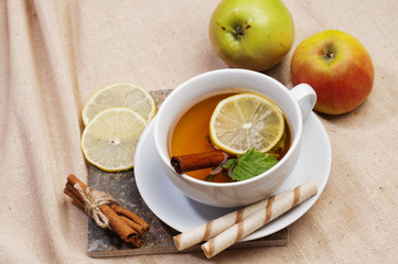 Tea with lemon, cinnamon sticks, tangerine