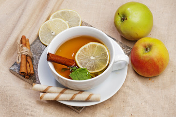 Tea with lemon, cinnamon sticks, tangerine