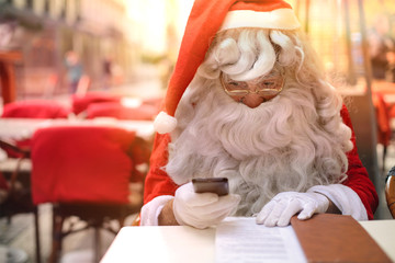 Santa Claus sending a text message