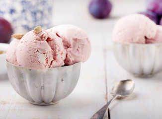 Plum ice cream with cardamon seeds. White background. 