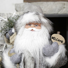 Christmas ornament of Santa Claus with a small welcome sign