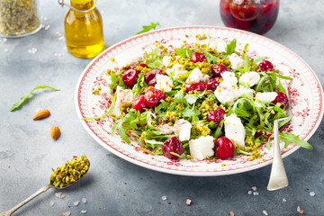 Salad with arugula, cherries and goat cheese.