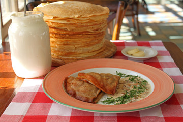 rolled pancakes on a plate with honey and powdered sugar