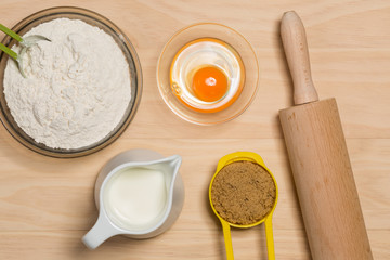 Fototapeta na wymiar flour, egg, milk, sugar and rolling pin