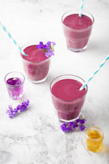 Blueberry, blackberry, honeysuckle, honeyberry smoothie with violet syrup and acai. 