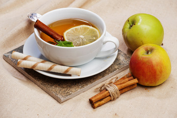 Tea with lemon, cinnamon sticks, tangerine