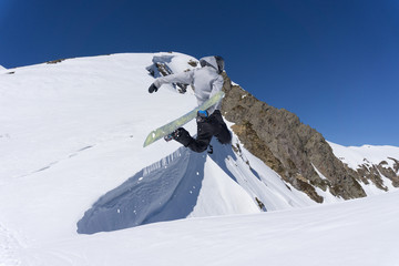 flying snowboarder on mountains