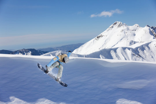 flying snowboarder on mountains