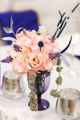 Flowers bouquet in vase on the table. Wedding decoration, decor. Holiday decoration flowers.
