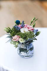 Flowers bouquet in vase on the table. Wedding decoration, decor. Holiday decoration flowers.
