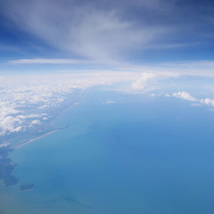 Land and sea under blue sky, view from the airplane. (2)