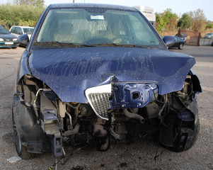 Obraz na płótnie Canvas Smashed Bonnet on Blue Car 