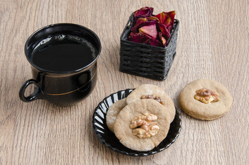 A Cup of coffee and cookies with walnuts