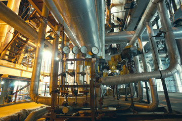 Equipment, cables and piping as found inside of a modern industr